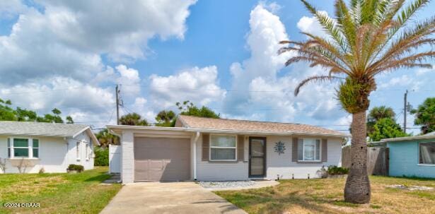 single story home with a garage and a front lawn