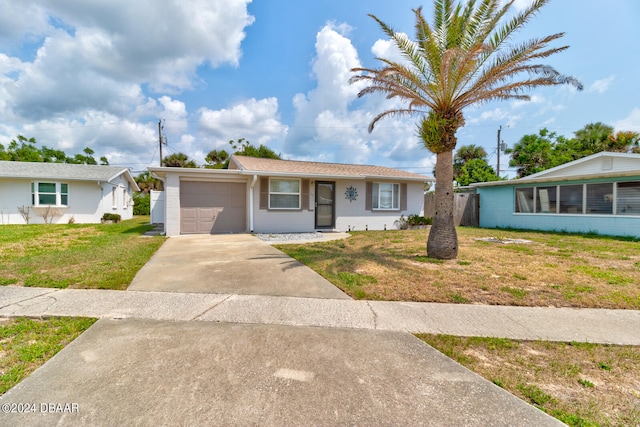 single story home featuring a garage and a front lawn