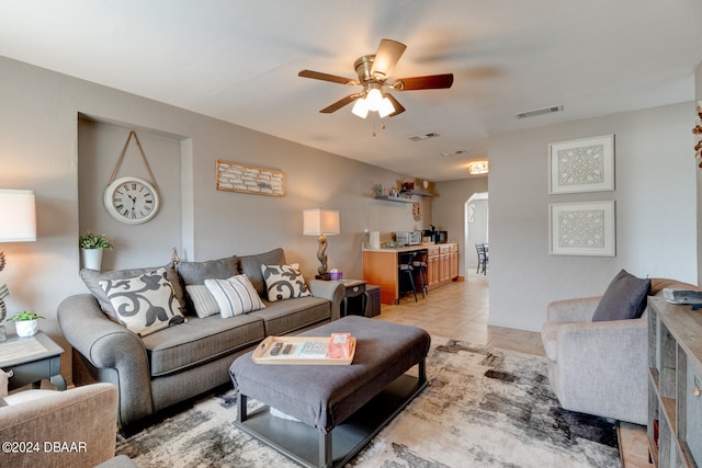 living room featuring light tile patterned flooring and ceiling fan