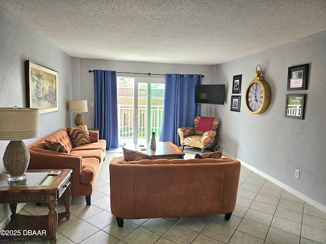 living room with tile patterned floors and a textured ceiling