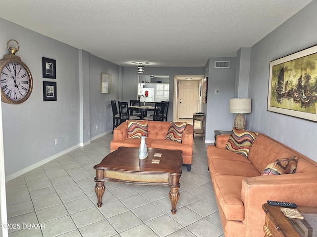 living room featuring light tile patterned floors and a textured ceiling