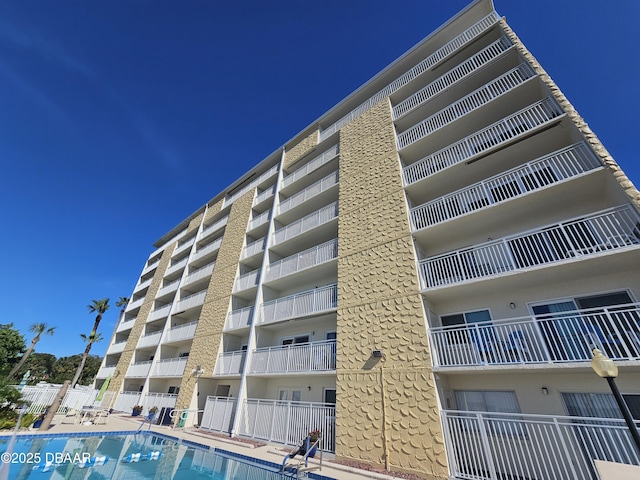 view of building exterior with a community pool