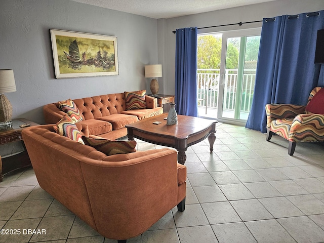 tiled living room featuring a textured ceiling