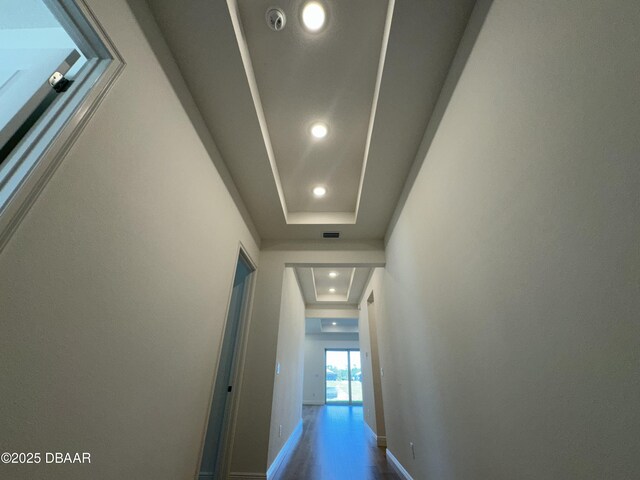 2009 Divot Dr, Daytona Beach, FL 32124 - hall with wood finished floors, baseboards, visible vents, recessed lighting, and a raised ceiling