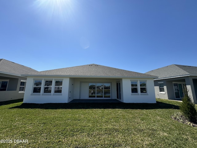 2009 Divot Dr, Daytona Beach, FL 32124 - rear view of property featuring stucco siding, a lawn, and a shingled roof