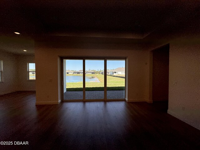 2009 Divot Dr, Daytona Beach, FL 32124 - unfurnished room featuring recessed lighting, baseboards, wood finished floors, and a water view