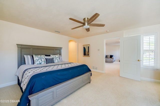 bedroom featuring visible vents, light colored carpet, and baseboards