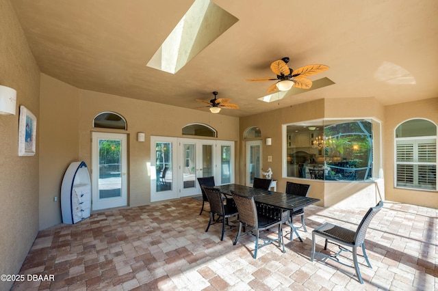 view of patio with french doors, outdoor dining area, and ceiling fan