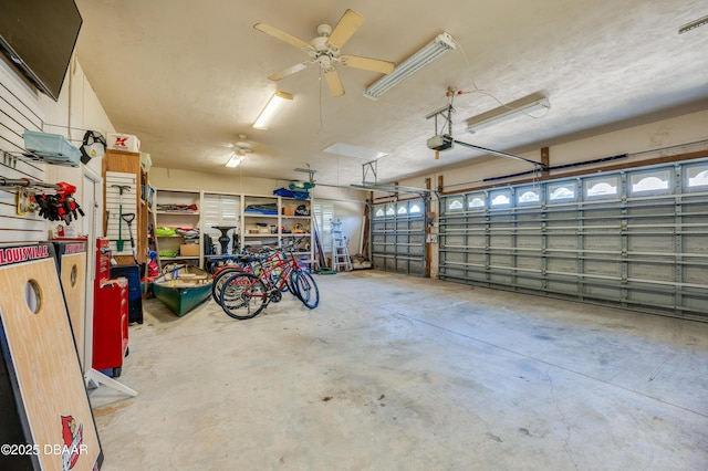 garage featuring a ceiling fan and a garage door opener