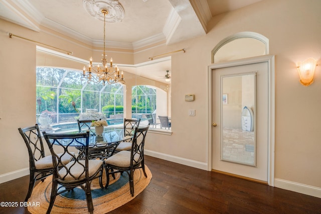 dining area featuring ceiling fan with notable chandelier, crown molding, baseboards, and wood finished floors