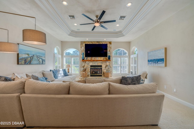 living area with carpet flooring, a fireplace, a wealth of natural light, and ceiling fan