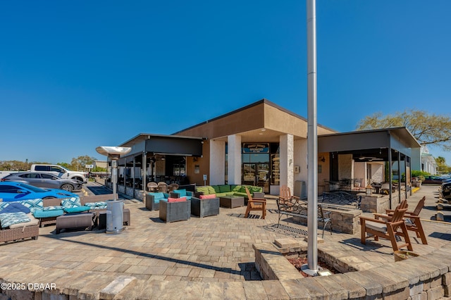 view of patio / terrace featuring an outdoor living space with a fire pit