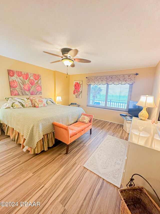 bedroom with hardwood / wood-style floors and ceiling fan