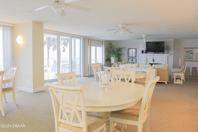 dining room featuring light carpet and ceiling fan