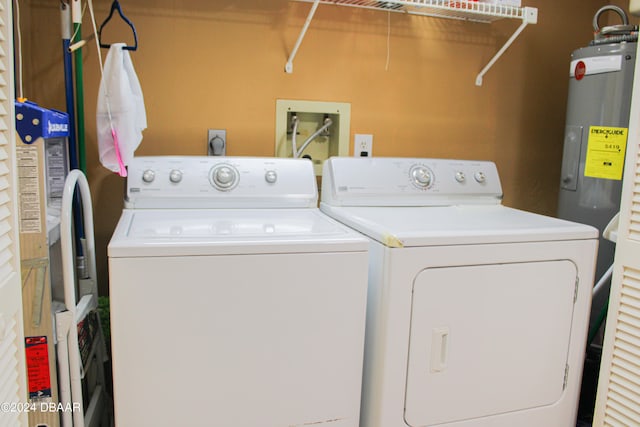 clothes washing area with electric water heater and washer and dryer