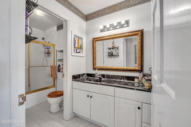 full bathroom with vanity, tile patterned floors, shower / bath combination with glass door, and toilet