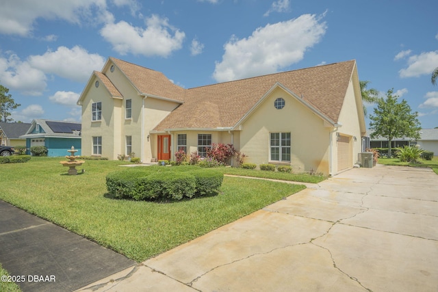 view of front of property with a garage and a front yard