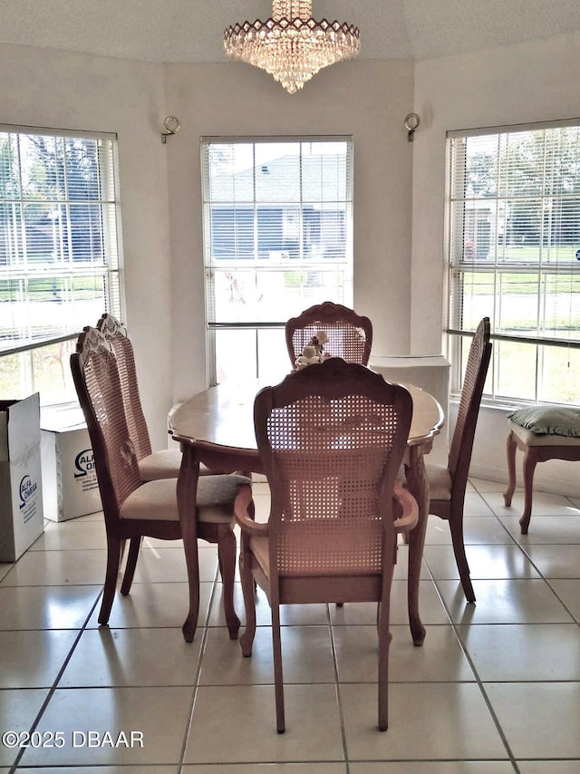 dining room featuring an inviting chandelier and light tile patterned floors