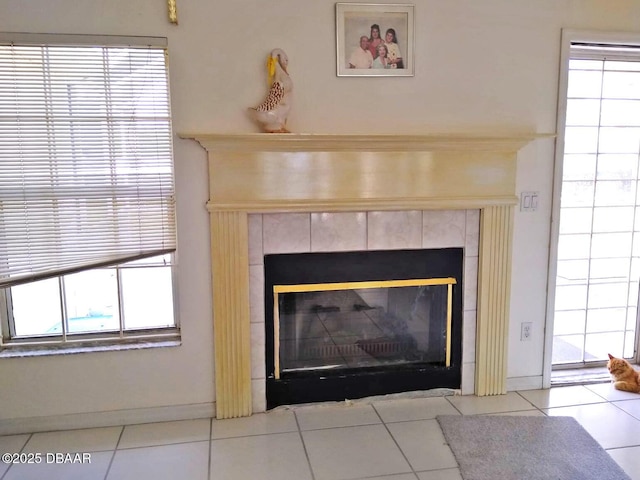 interior details featuring a tile fireplace