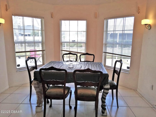 dining space featuring light tile patterned floors and a healthy amount of sunlight