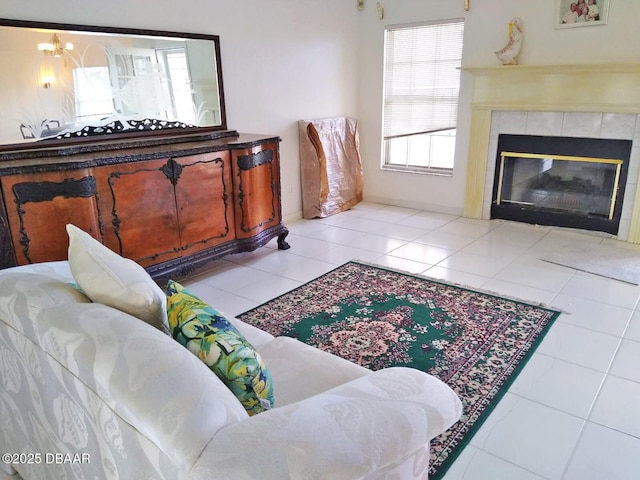 tiled living room with a notable chandelier and a tile fireplace