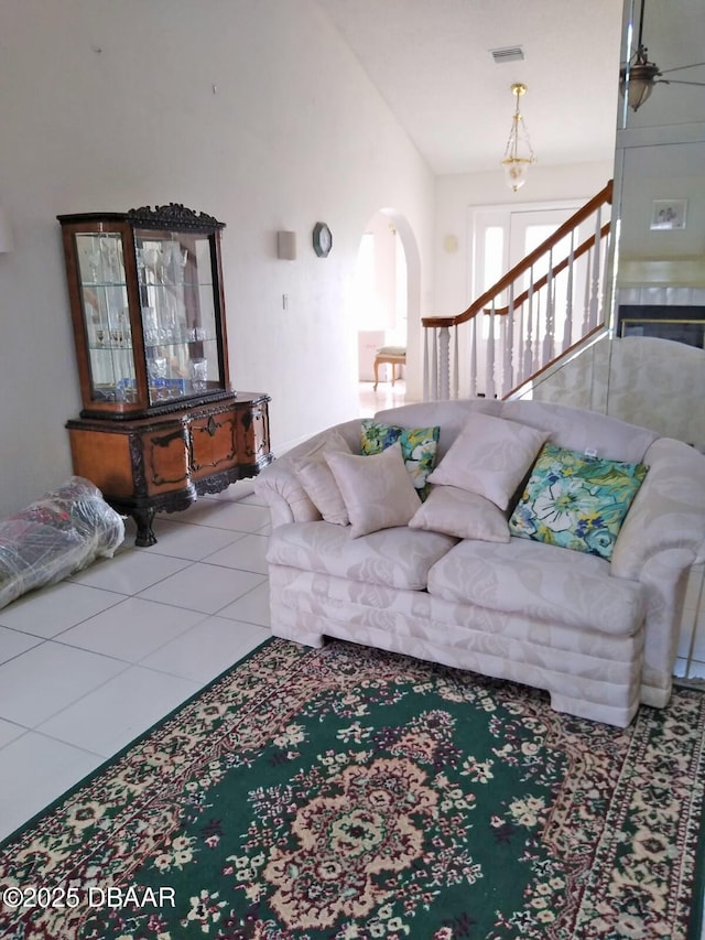 tiled living room featuring lofted ceiling