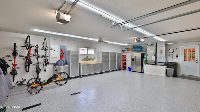 garage with ceiling fan, stainless steel fridge, and a garage door opener