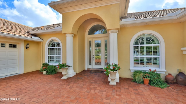 view of exterior entry with a garage