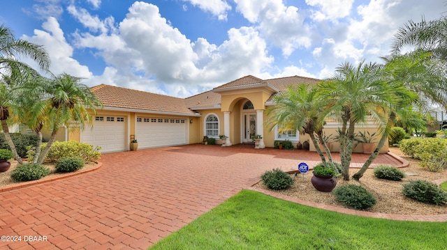 mediterranean / spanish house featuring a garage