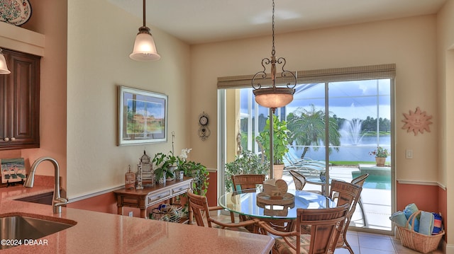 dining room featuring light tile patterned flooring and sink