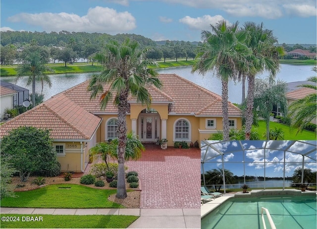 exterior space featuring a water view and glass enclosure