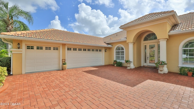 mediterranean / spanish-style home featuring a garage