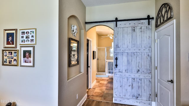 corridor featuring hardwood / wood-style floors and a barn door