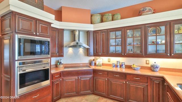 kitchen with black appliances, light tile patterned flooring, wall chimney range hood, and tasteful backsplash