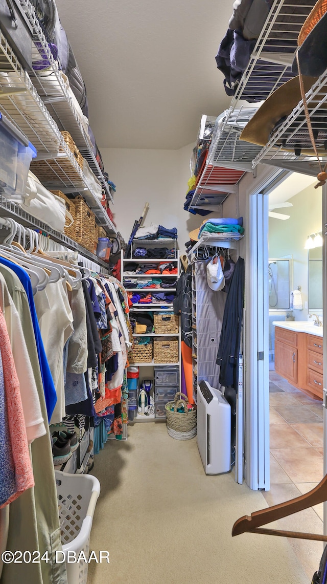 spacious closet featuring light tile patterned floors