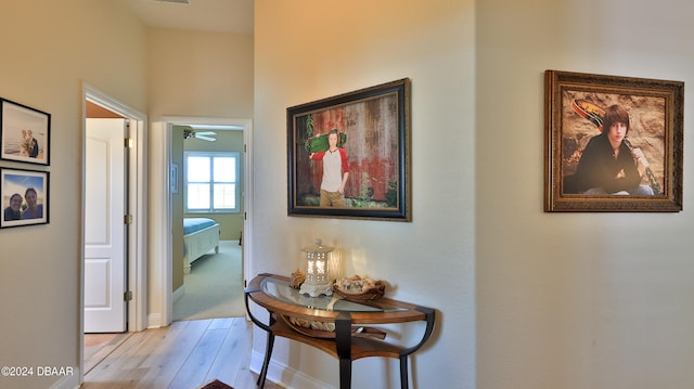 hallway with light hardwood / wood-style floors