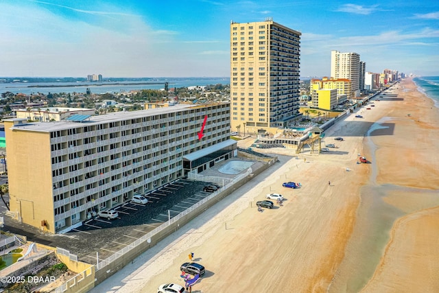 drone / aerial view with a water view and a beach view