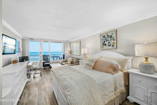 bedroom featuring crown molding, access to exterior, and hardwood / wood-style flooring