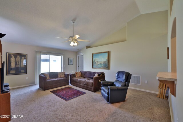 living room featuring vaulted ceiling, light colored carpet, and ceiling fan