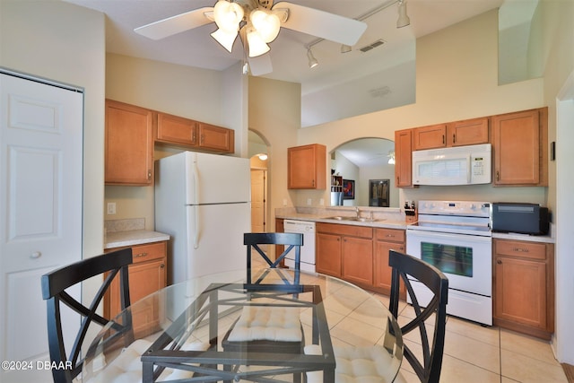 kitchen with light tile patterned flooring, track lighting, sink, white appliances, and ceiling fan