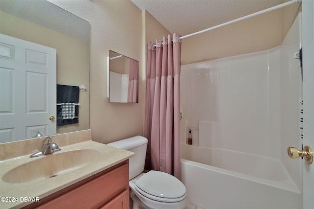 full bathroom featuring toilet, vanity, shower / bath combo with shower curtain, and a textured ceiling