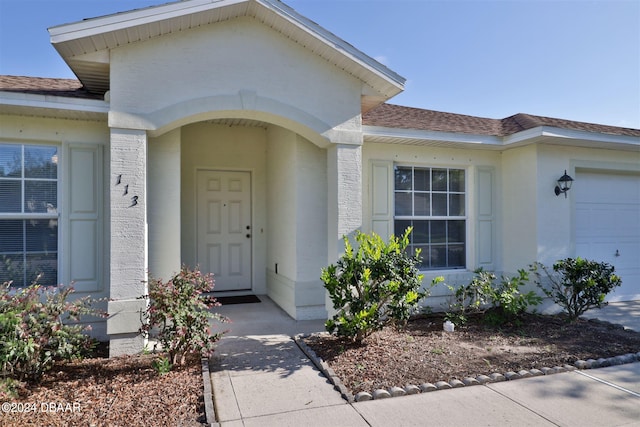 view of exterior entry featuring a garage