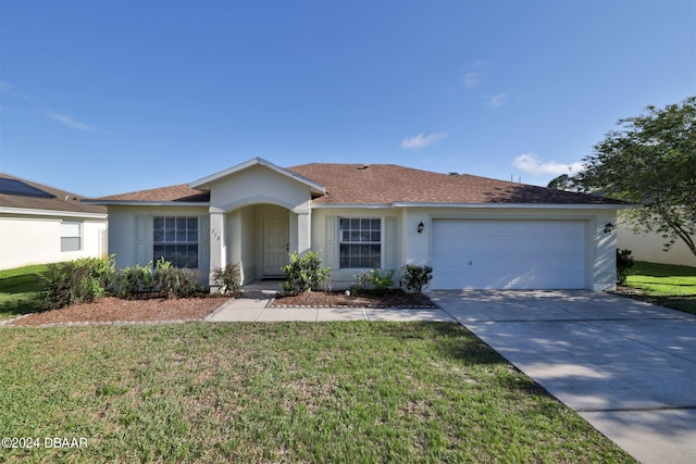 ranch-style home with a garage and a front lawn