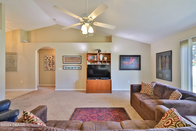 carpeted living room with ceiling fan and lofted ceiling