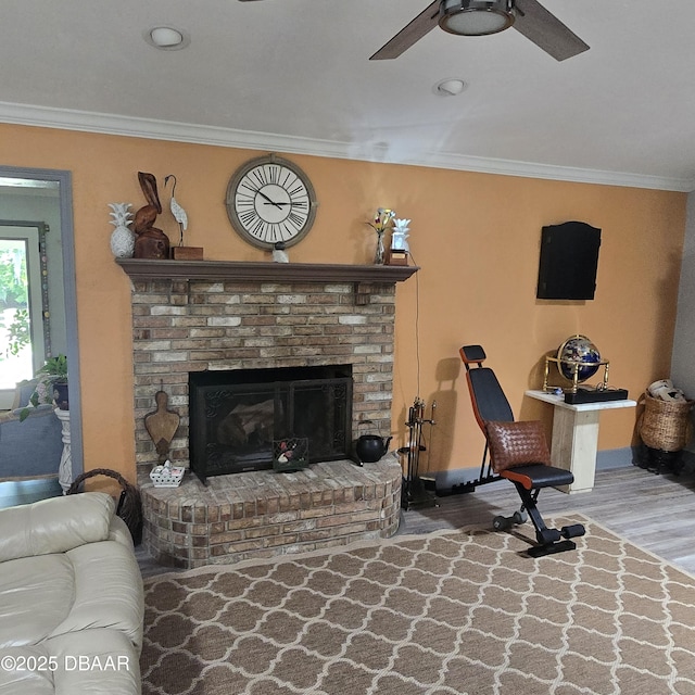 1010 Bolton Rd, New Smyrna Beach, FL 32168 - living room featuring wood finished floors, a brick fireplace, crown molding, baseboards, and ceiling fan