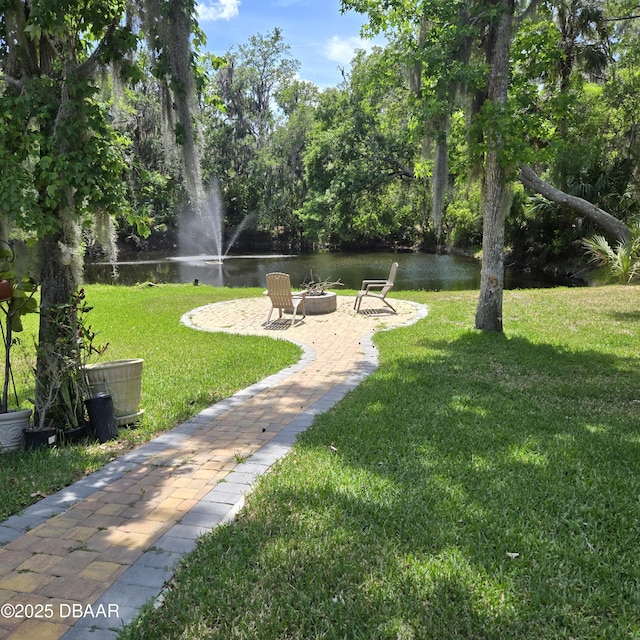 1010 Bolton Rd, New Smyrna Beach, FL 32168 - view of property's community featuring an outdoor fire pit, a water view, and a lawn