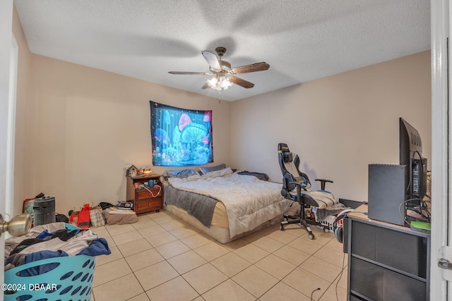 tiled bedroom featuring ceiling fan and a textured ceiling