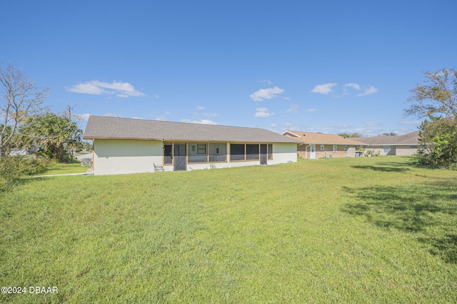 back of house with a yard