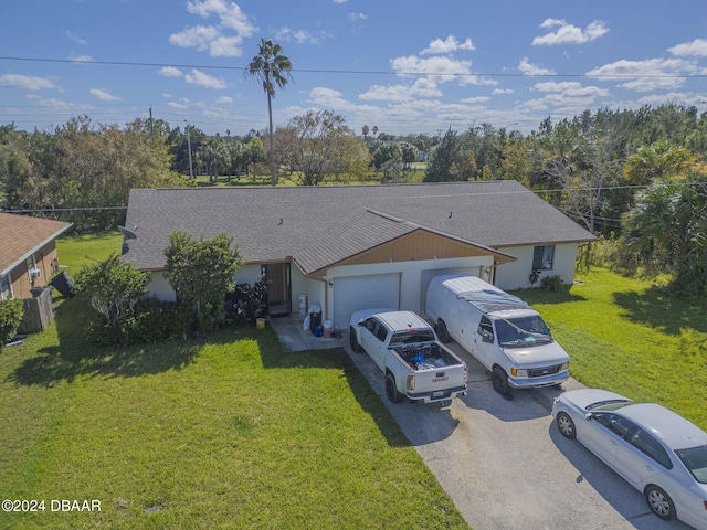 ranch-style home with a front lawn and a garage