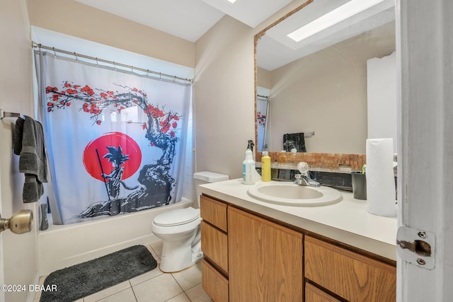 full bathroom featuring shower / bath combination with curtain, tile patterned floors, vanity, toilet, and a skylight